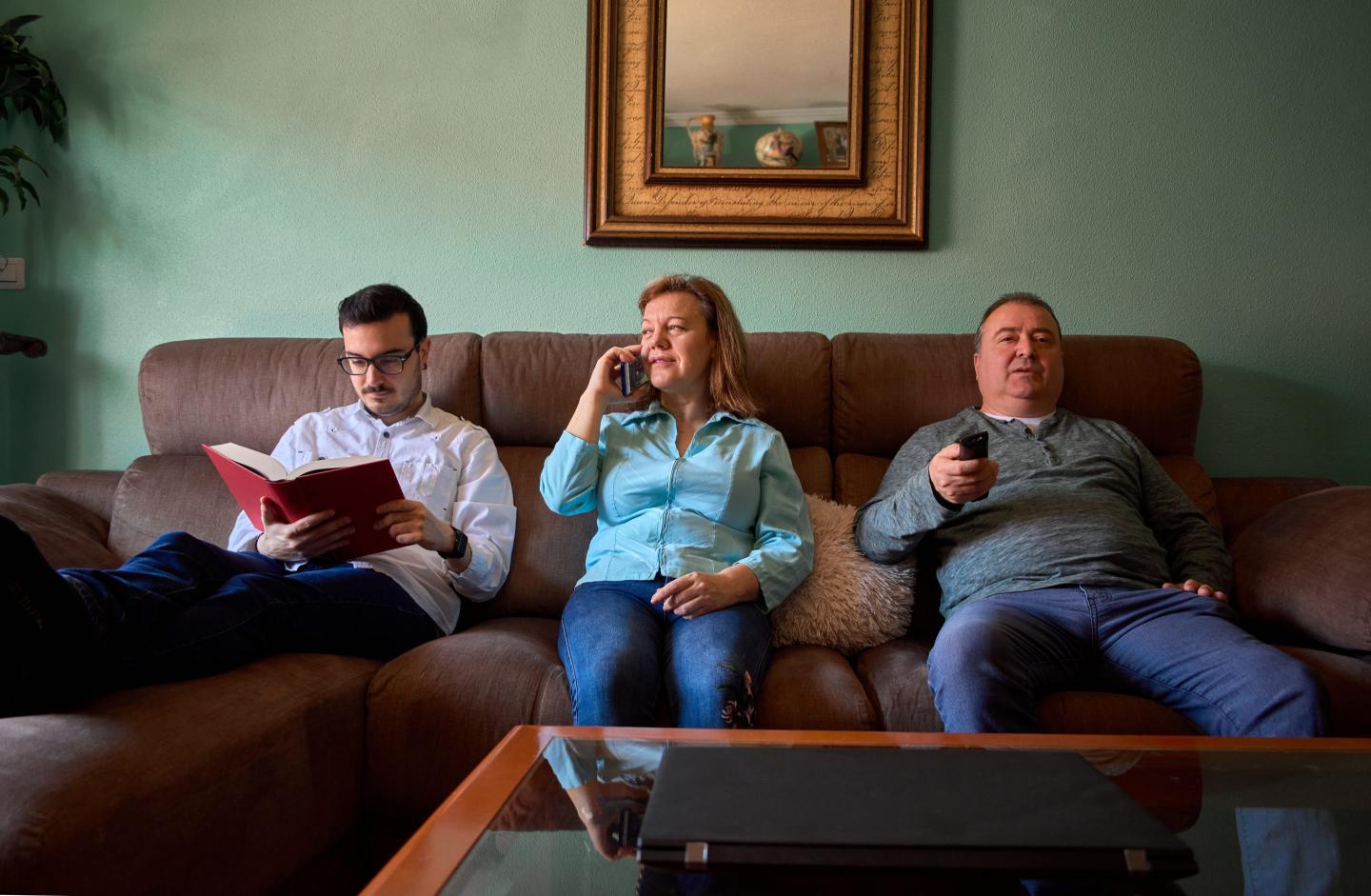 Family members sitting on a sofa together