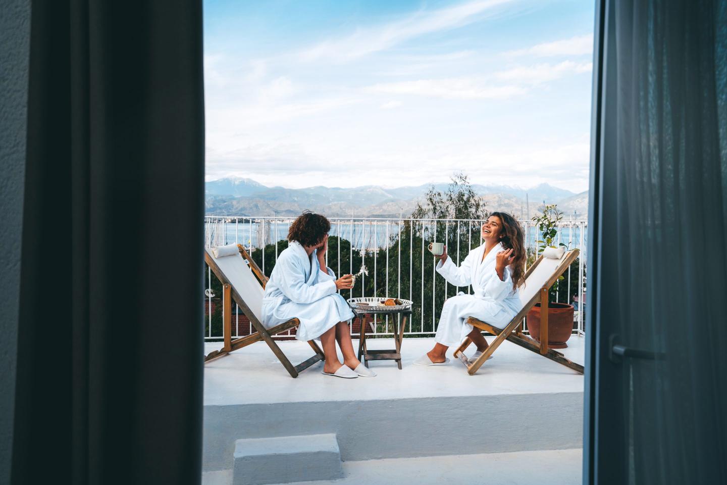 Photo of two friends in bathrobes enjoying tea