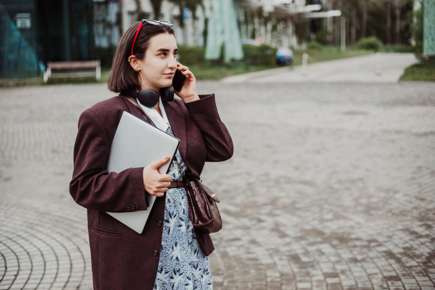 Young woman talking on her phone while walking