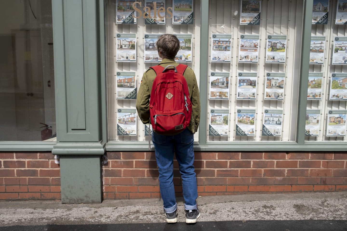 A young person looks at home listings.