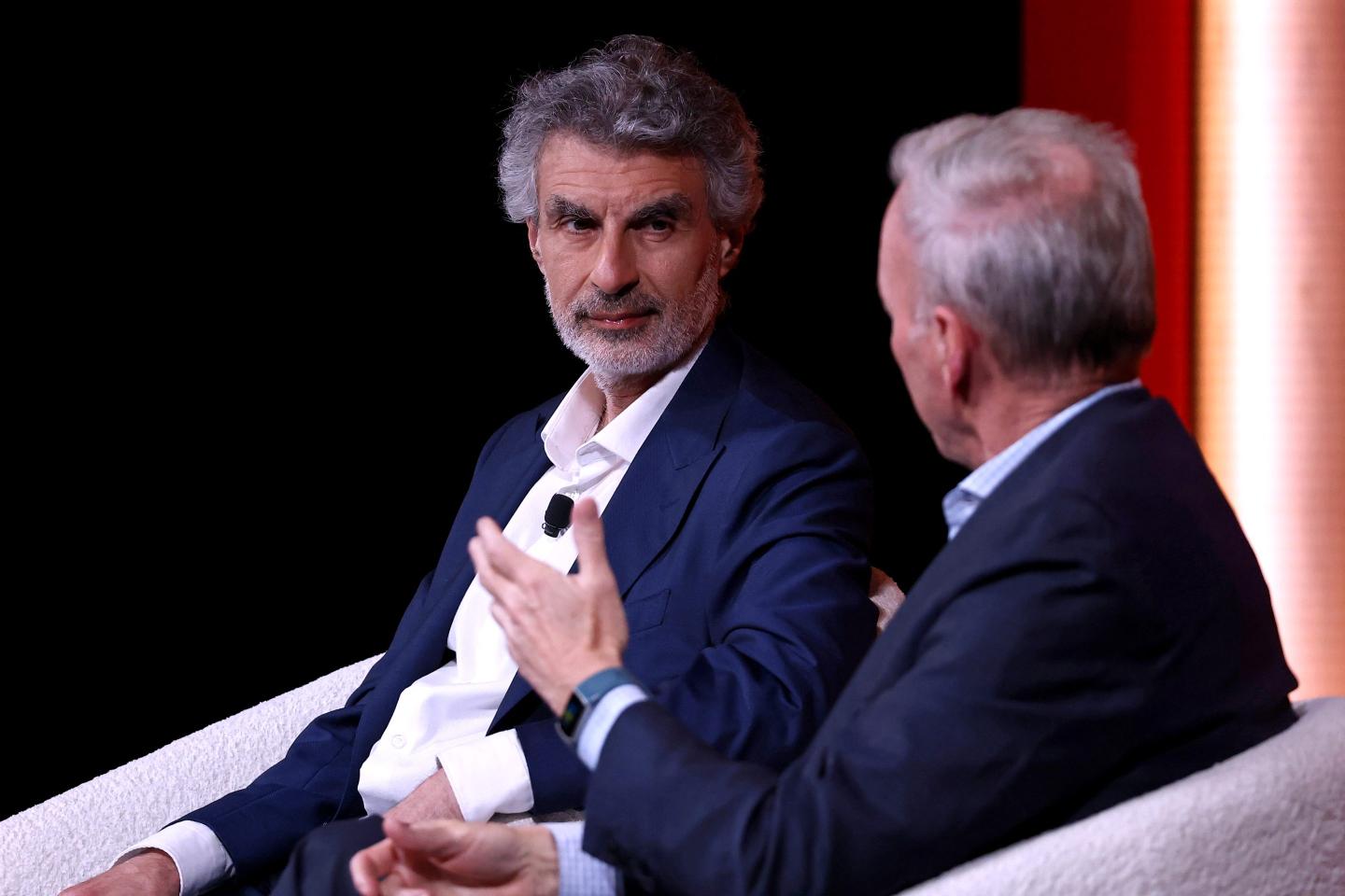 Yoshua Bengio seated on a stage.