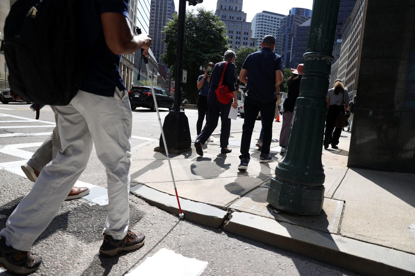 Photo of a blind person approaching a curb