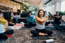 Business people doing relaxation exercises and yoga in an office.