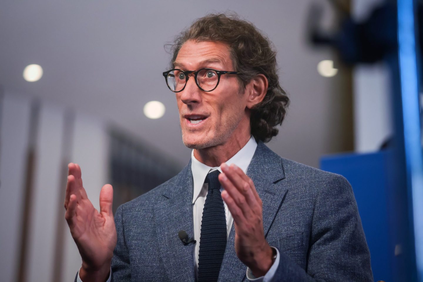 Man with glasses gesturing with his hands