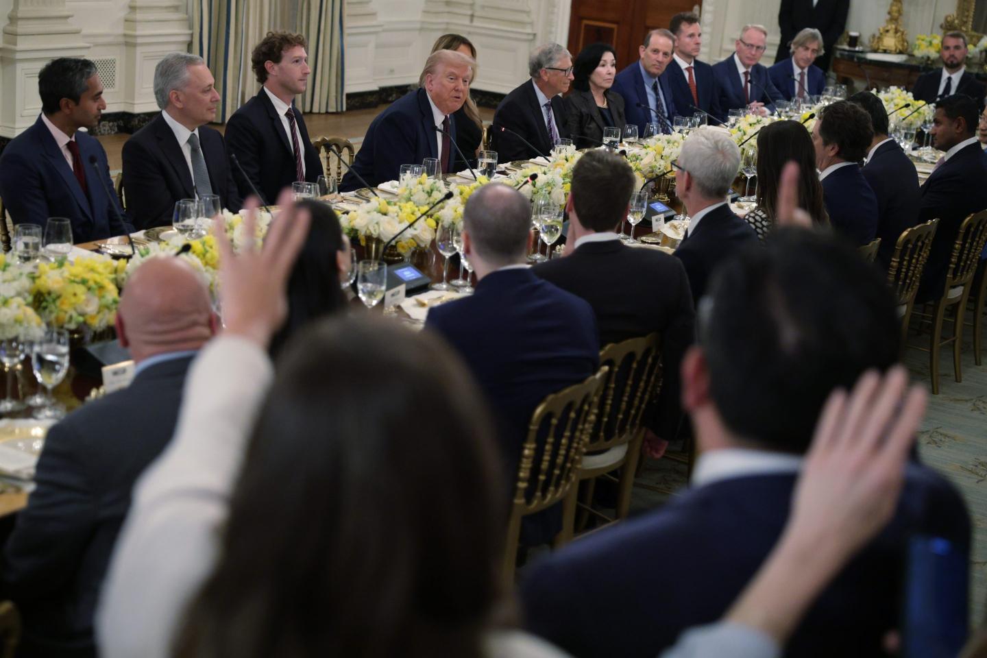 Tech leaders, Donald Trump, and Melania Trump sit at a table.