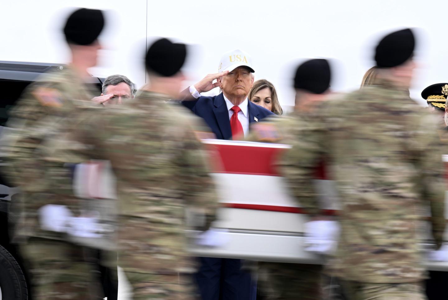 U.S. President Donald Trump salutes as a U.S. Army carry team moves a flag-draped transfer case containing the remains of Sgt. Declan J. Coady at Dover Air Force Base on March 07, 2026 in Dover, Delaware.