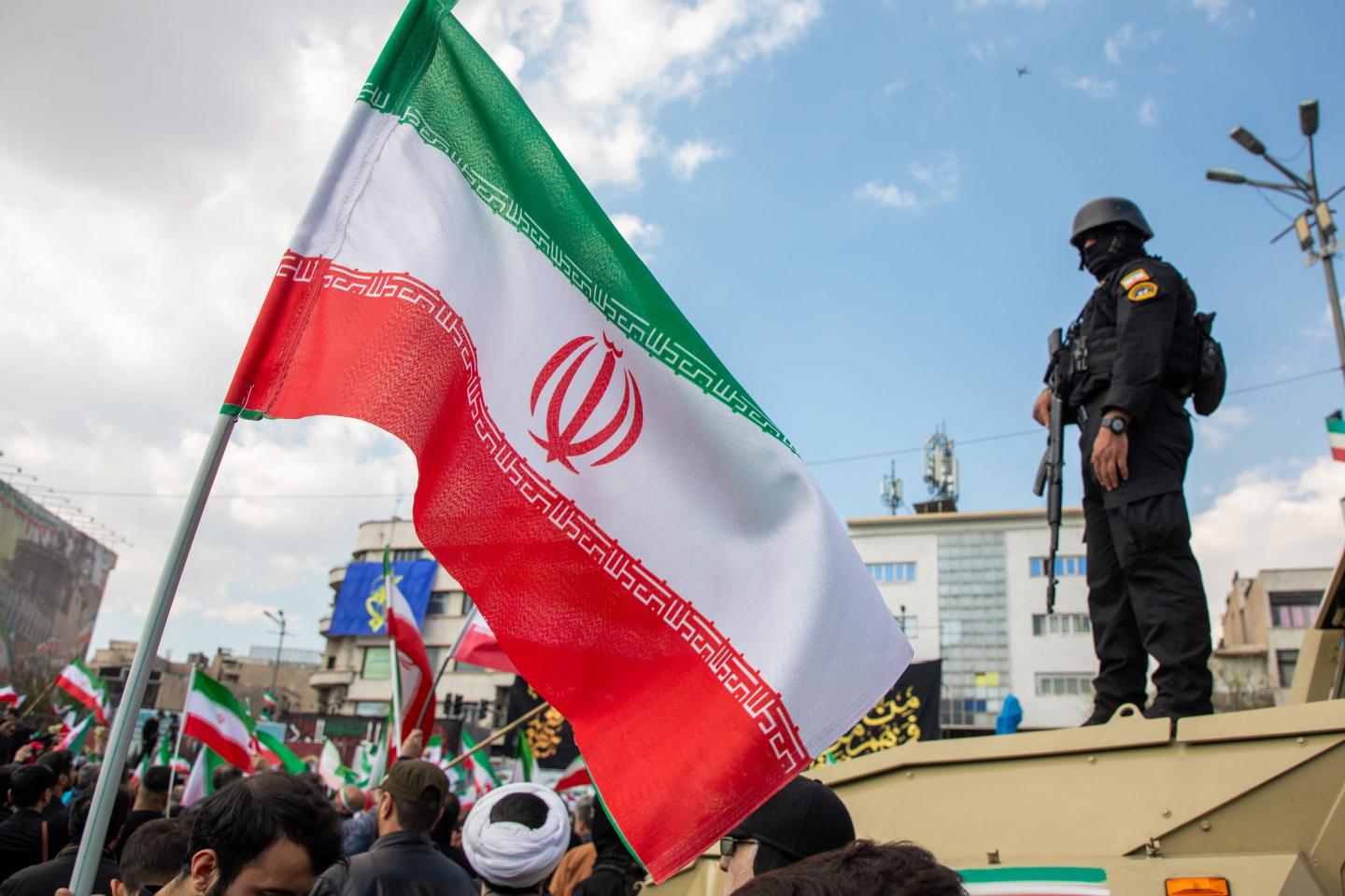 Members of security forces watch over the crowd during a funeral procession held for IRGC Navy Chief Alireza Tangsiri, alongside other senior naval commanders and their families who were killed in US-Israeli strikes in late March, on April 1, 2026 in Tehran, Iran.