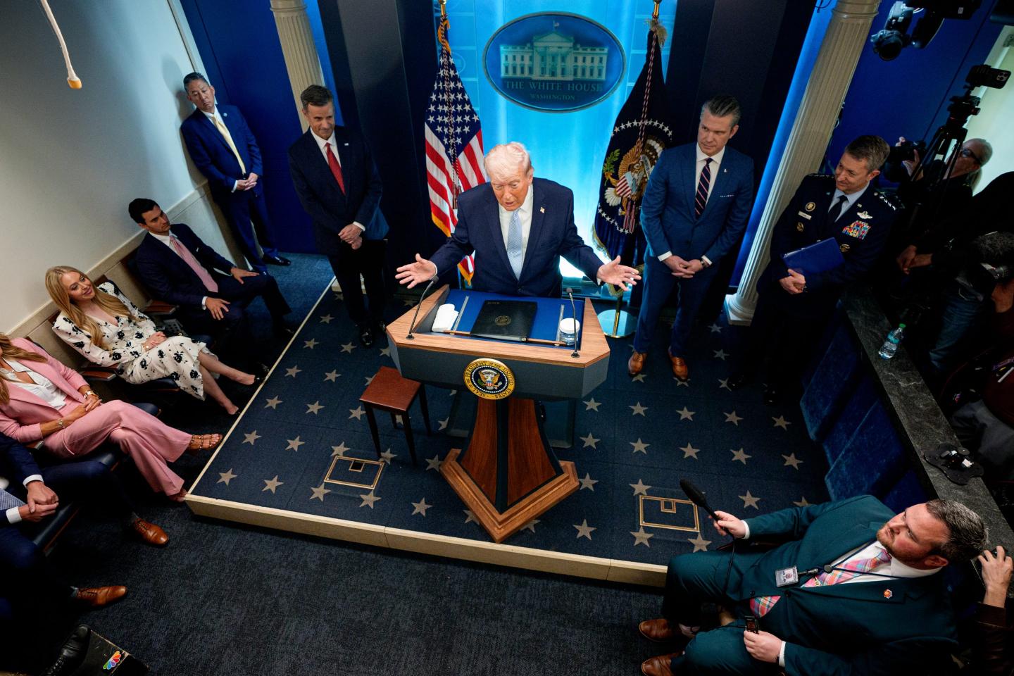 U.S. President Donald Trump, accompanied by CIA Director John Ratcliffe (C-L), Secretary of War Pete Hegseth (2nd-R) and Chairman of the Joint Chiefs of Staff General Dan Caine (R), speaks during a news conference at the White House on April 6, 2026.