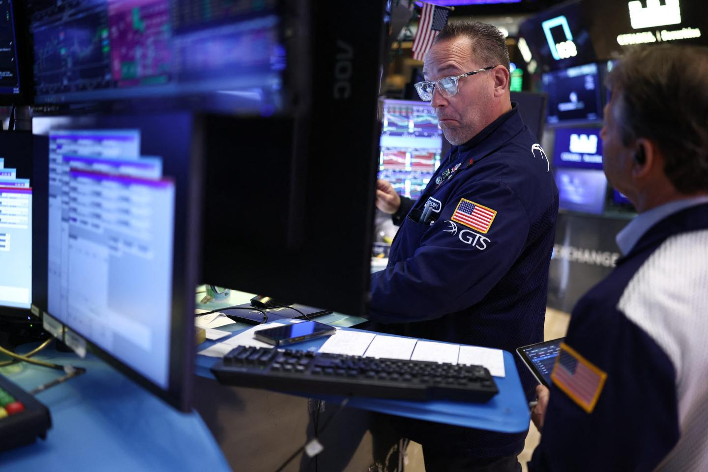 Traders work on the floor of the New York Stock Exchange (NYSE) at the opening bell in New York City on April 7, 2026.
