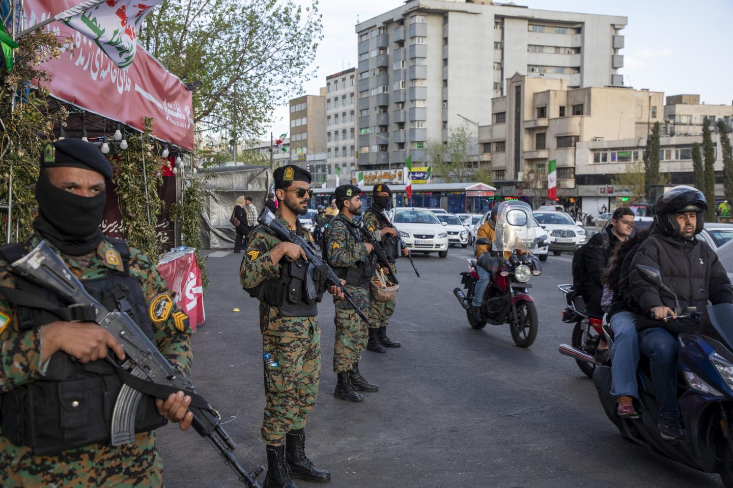 Members of Iran’s security forces stand guard in Enqelab Square during a demonstration in support of the Iranian government April 5, 2026, in Tehran.