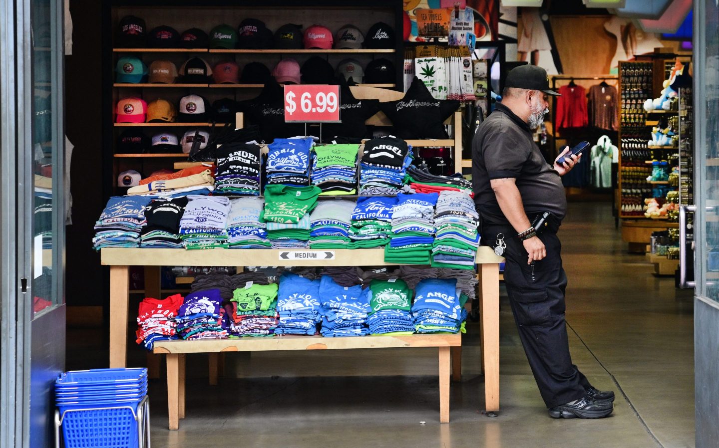 man leaning against t shirt stand