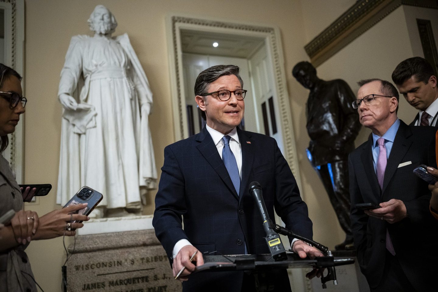 Mike Johnson speaks at a podium.