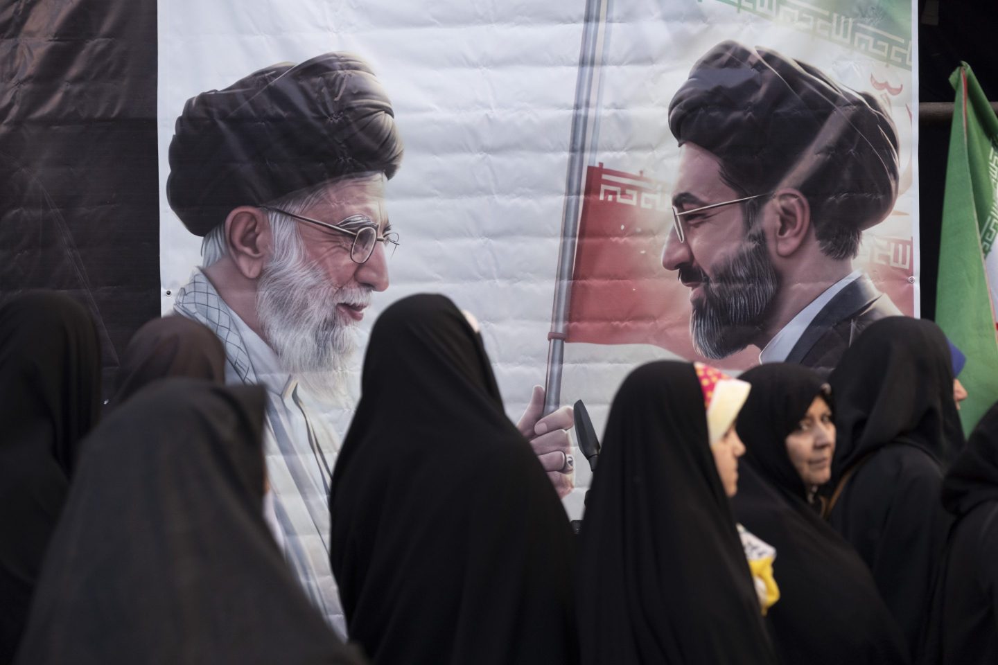 A banner depicting portraits of Iran's late Supreme Leader Ayatollah Ali Khamenei and Ayatollah Mojtaba Khamenei