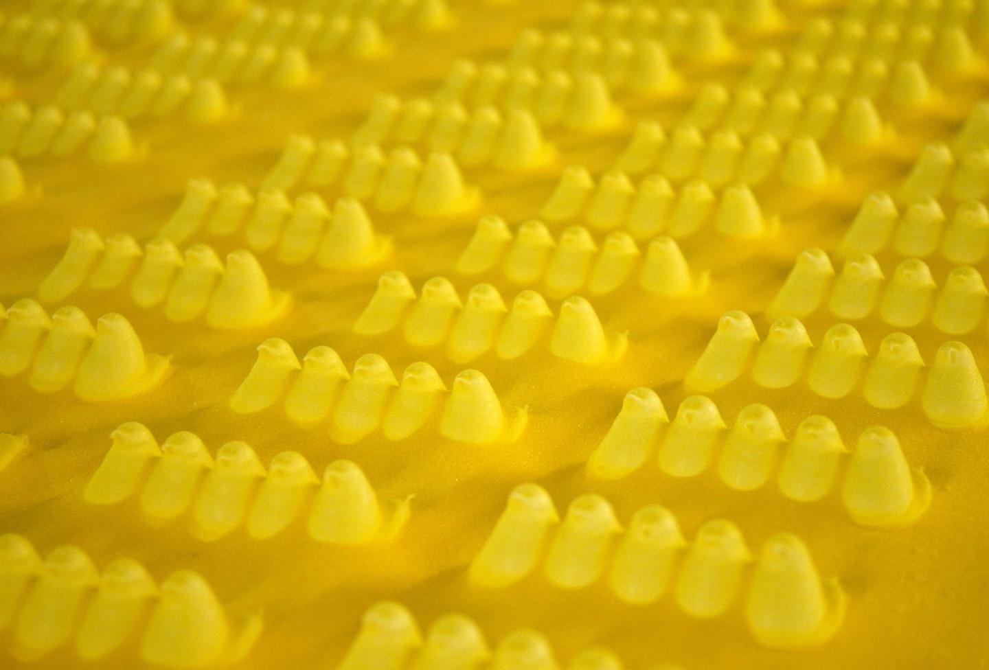 Peeps in yellow dye on a conveyor belt