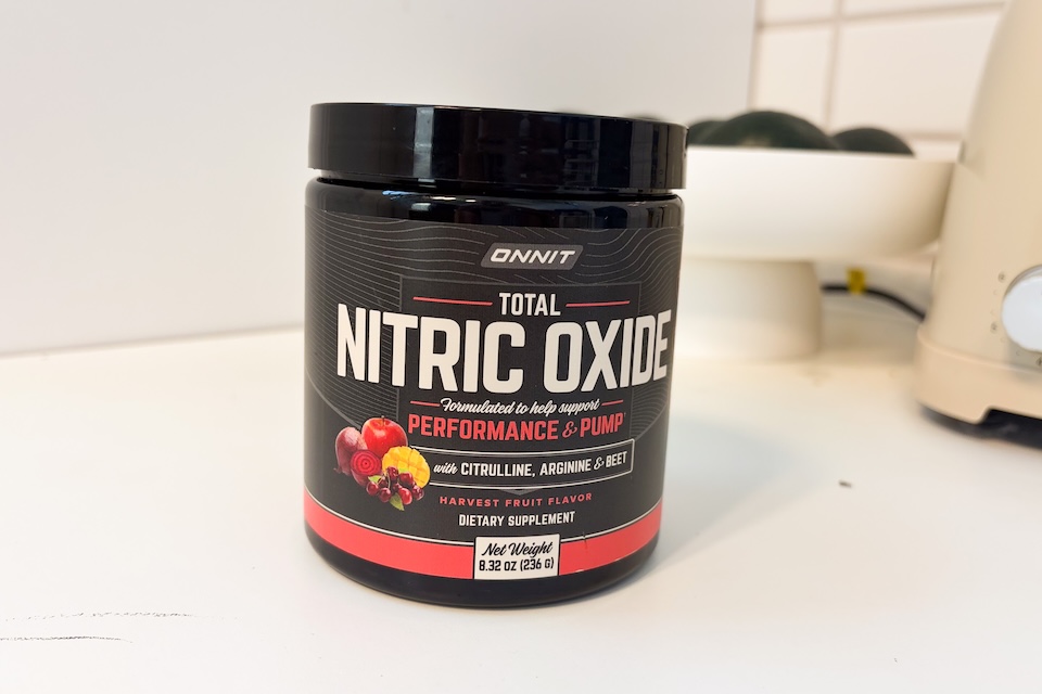 A canister of Onnit Total Nitric Oxide sitting on a white countertop.