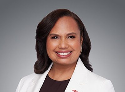 Dow COO Karen Carter wearing a white lab coat