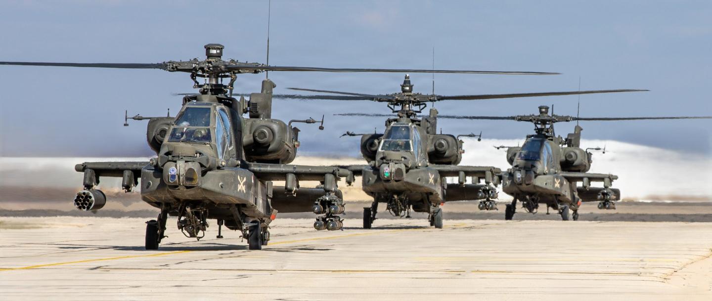 A flight of U.S. Army AH-64 Apache attack helicopters, armed with rockets and Hellfire missiles, taxi out to conduct a scheduled flight in the U.S. Central Command area of responsibility.