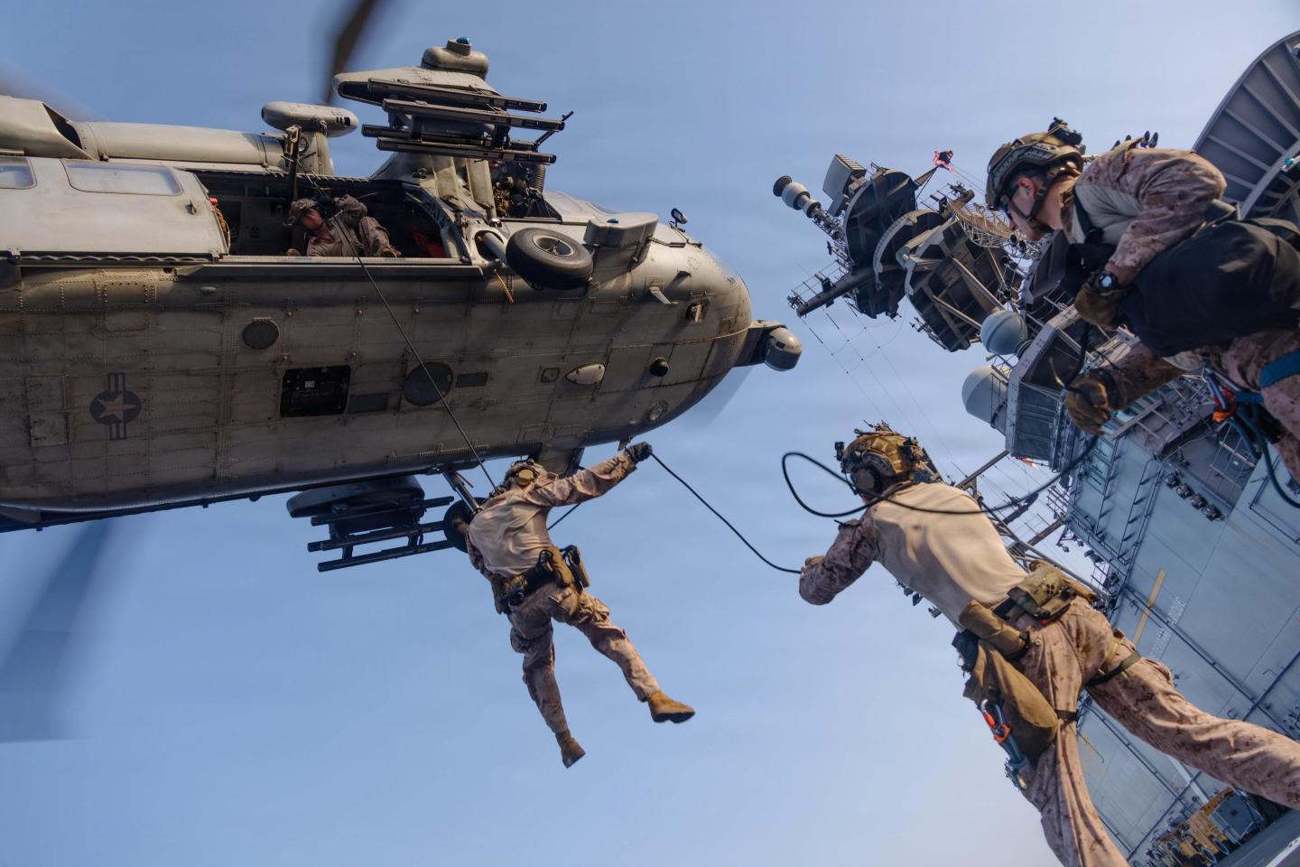 U.S. Marines with Maritime Raid Force, 31st Marine Expeditionary Unit, rappel out of an MH-60S Sea Hawk, assigned to Helicopter Sea Combat (HSC) Squadron 25, during helicopter and roping sustainment training aboard the forward-deployed amphibious assault ship USS Tripoli (LHA 7) in the U.S. Central Command area of responsibility, May 8, 2026. 