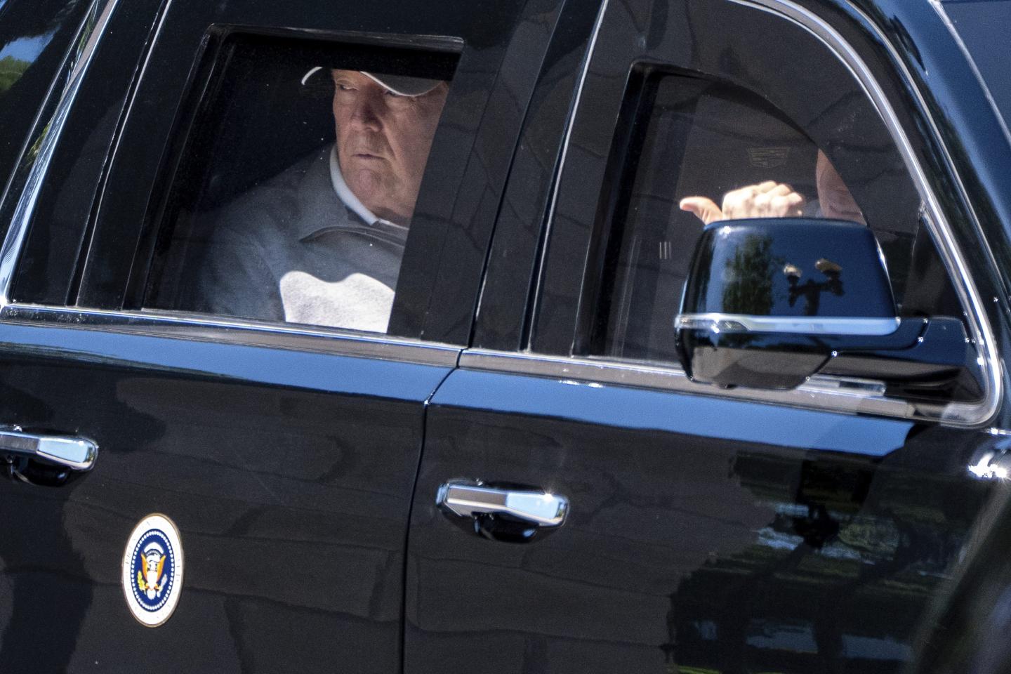 President Donald Trump looks out the window of his limousine at the construction in Lafayette Park as he departs the White House, Saturday, May 30, 2026, in Washington.
