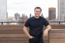 Allen Osgood, co-founder and CEO of Eisen, in front of the New York City skyline