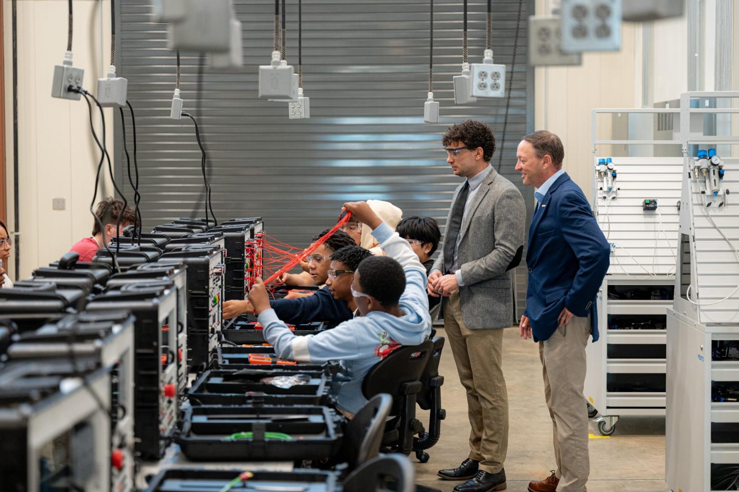 Marc Perry, Toyota Alabama president and Jack Crowley in the lab with the students.