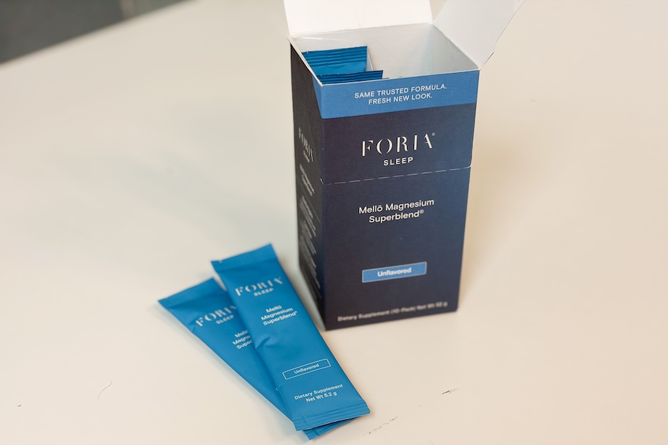 Two packets of Floria Sleep Mello Magnesium resting next to their box.
