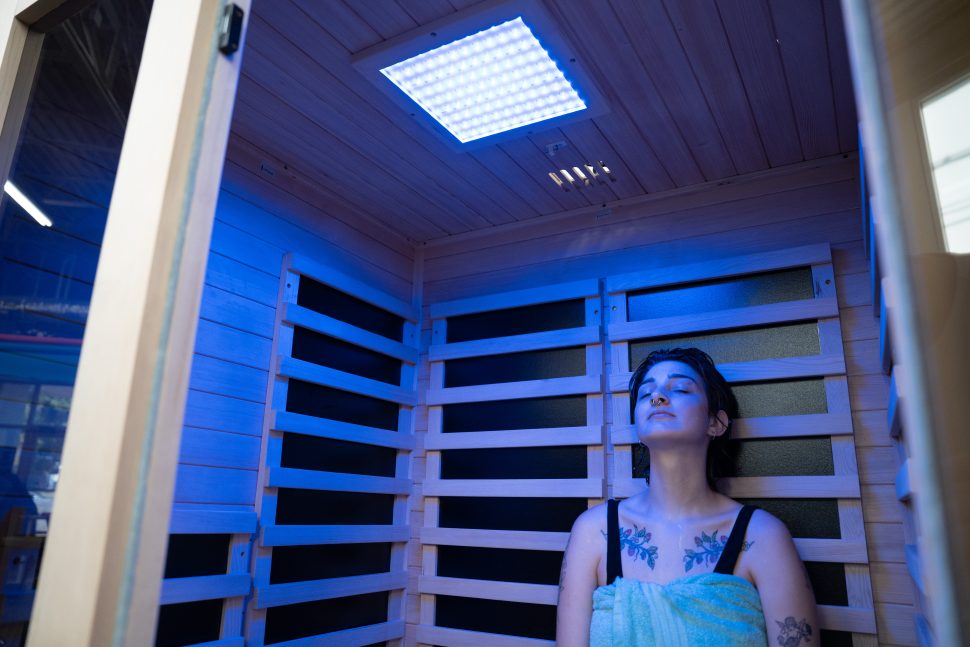 A woman sitting inside the Heavenly Heat sauna