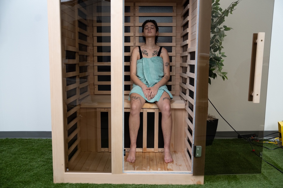 A woman sitting in the Heavenly Heat sauna