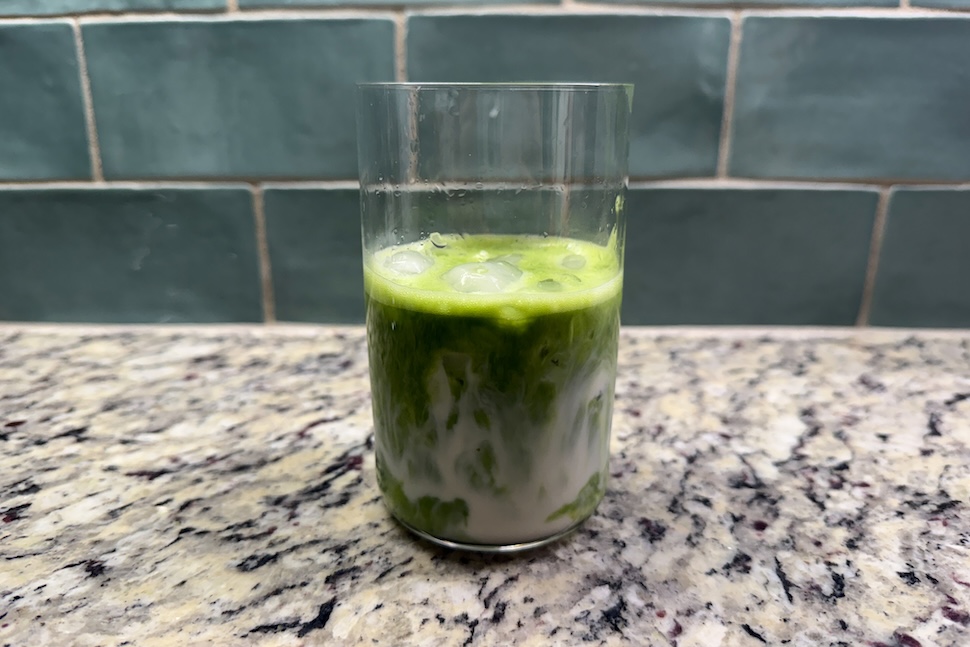 A glass of Mantra Matcha Super Premium Ceremonial Matcha with ice