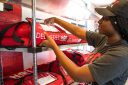A Pizza Hut workers prepares an order for delivery.