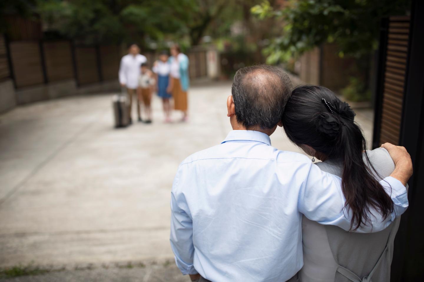 Grandparents saying goodbye to their loved ones at the door