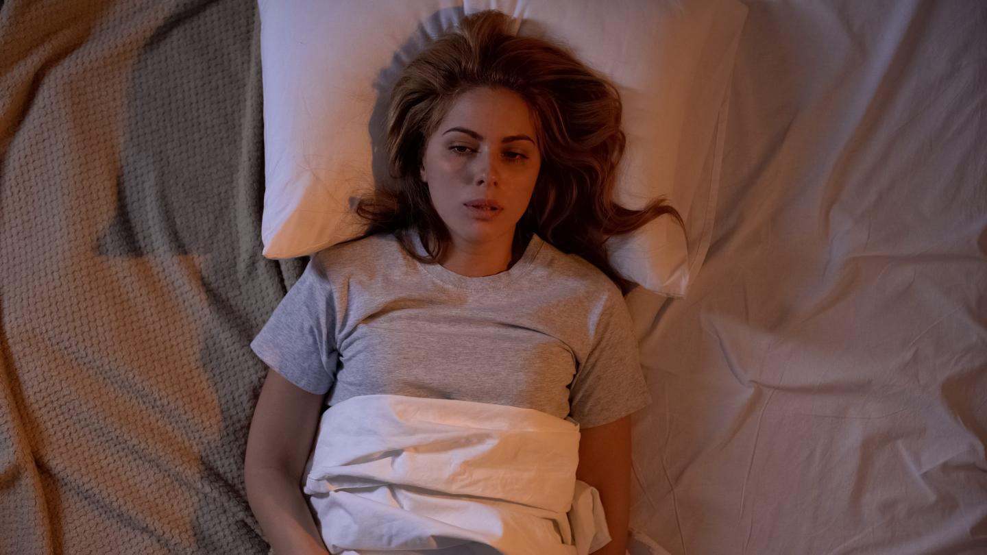Tired woman trying to sleep, life difficulties, feeling lonely and frustrated
