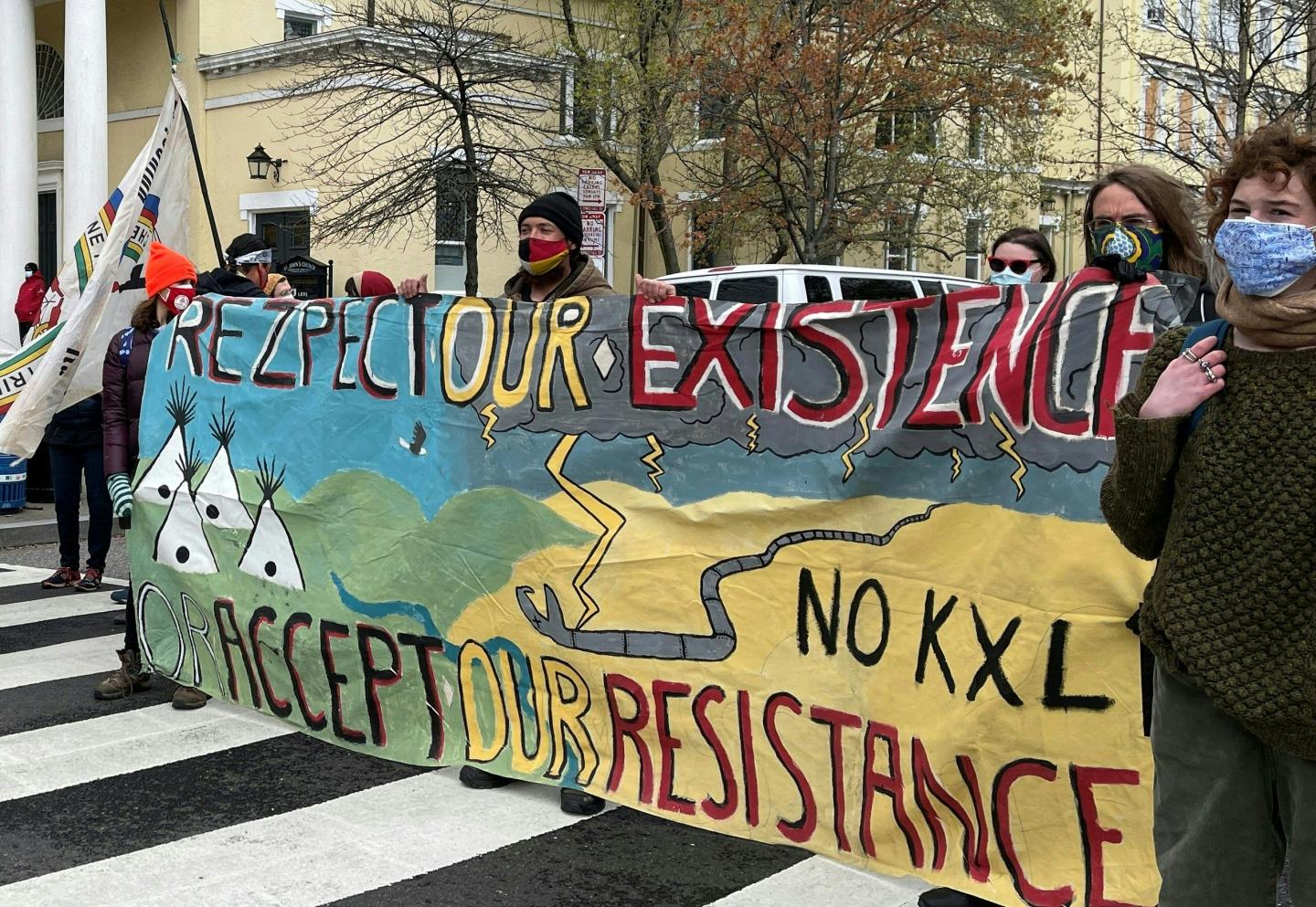 Activists display banners referring to the shutting down of existing oil pipelines in the northern United States in Washington, DC on April 1, 2021 one block from the White House. (Photo by Daniel SLIM / AFP) (Photo by DANIEL SLIM/AFP via Getty Images)