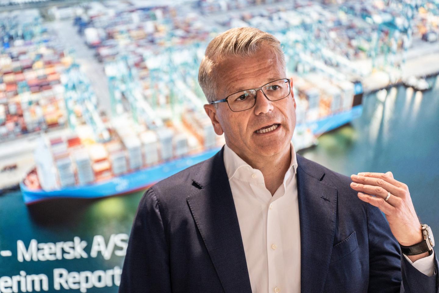 Vincent Clerc speaks in front of a picture of a port.