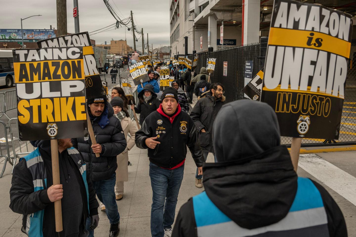 Amazon workers hold signs protestings