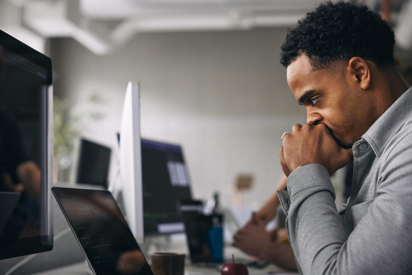 Young worker looking tired in front of a screen