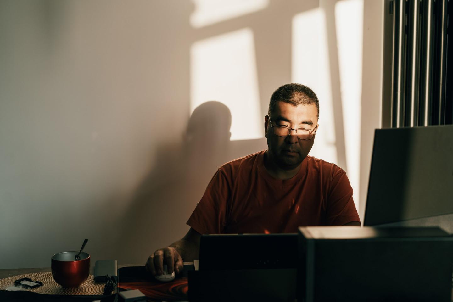 Man sitting staring at his computer.