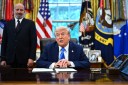 US President Donald Trump speaks before signing an executive order in the Oval Office at the White House in Washington, DC, as Commerce Secretary Howard Lutnick looks on.