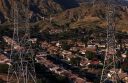 electrical transmission lines hang over a housing development on March 24, 2026 in Sylmar, California.