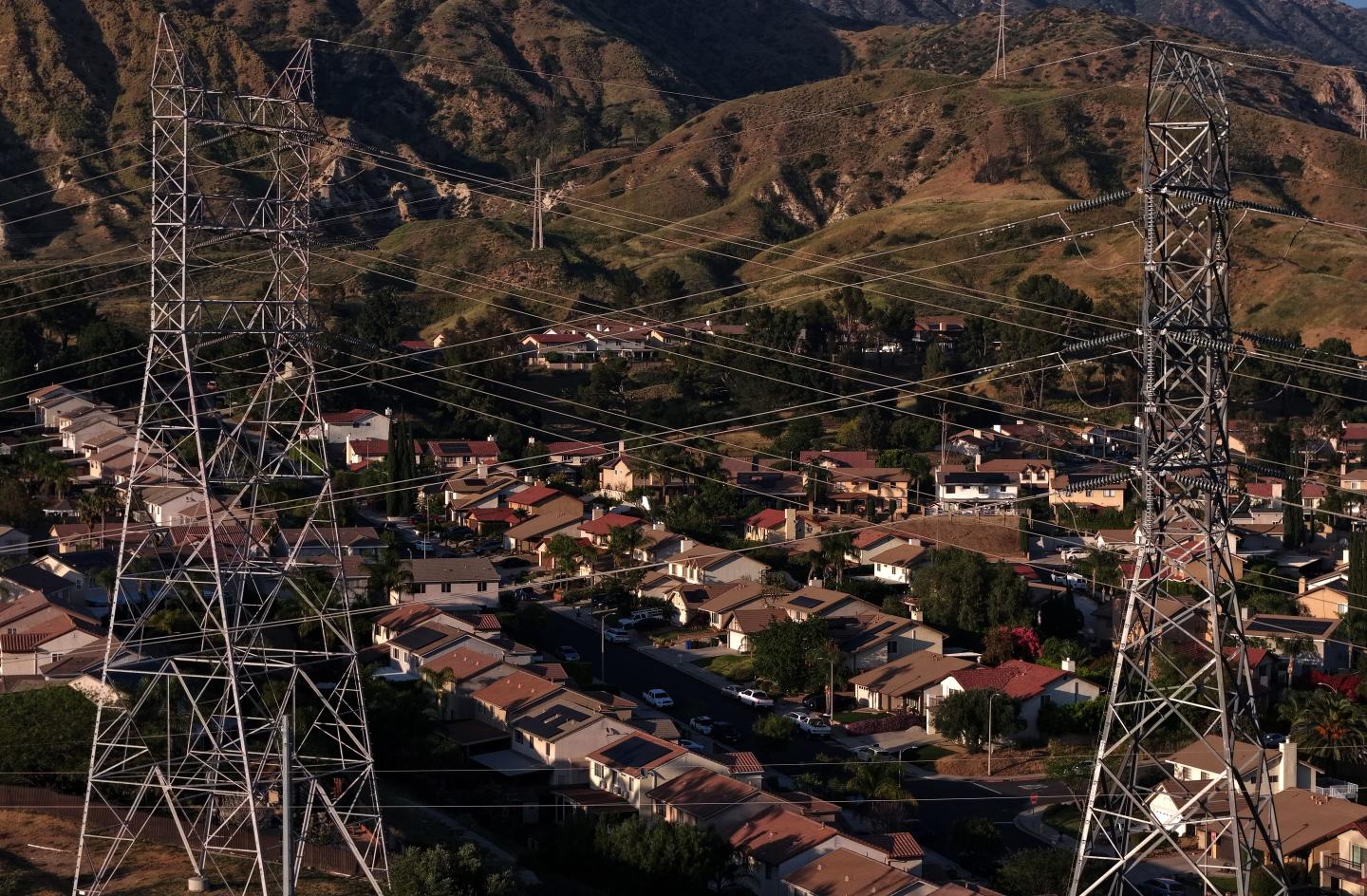 electrical transmission lines hang over a housing development on March 24, 2026 in Sylmar, California.