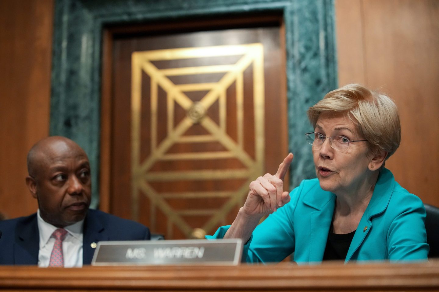 Elizabeth Warren speaks into a microphone during a Senate Banking Committee meeting