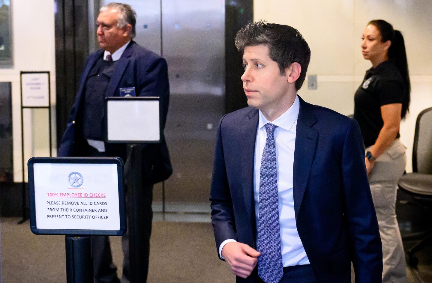 Sam Altman walks inside a courthouse