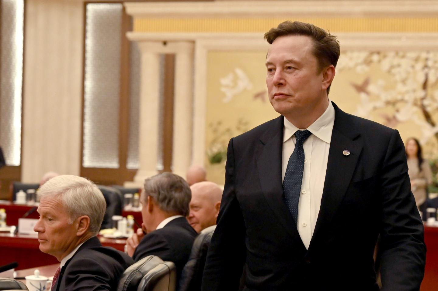 Elon Musk accompanies President Donald Trump on his visit to China on May 14, 2026. 