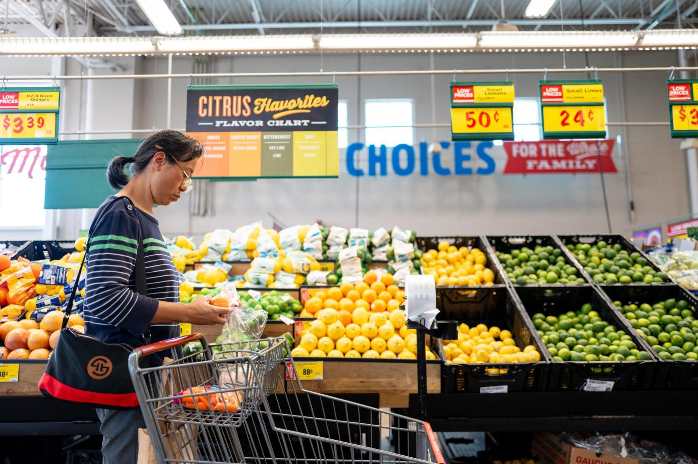 a woman looks at the produce she's buying