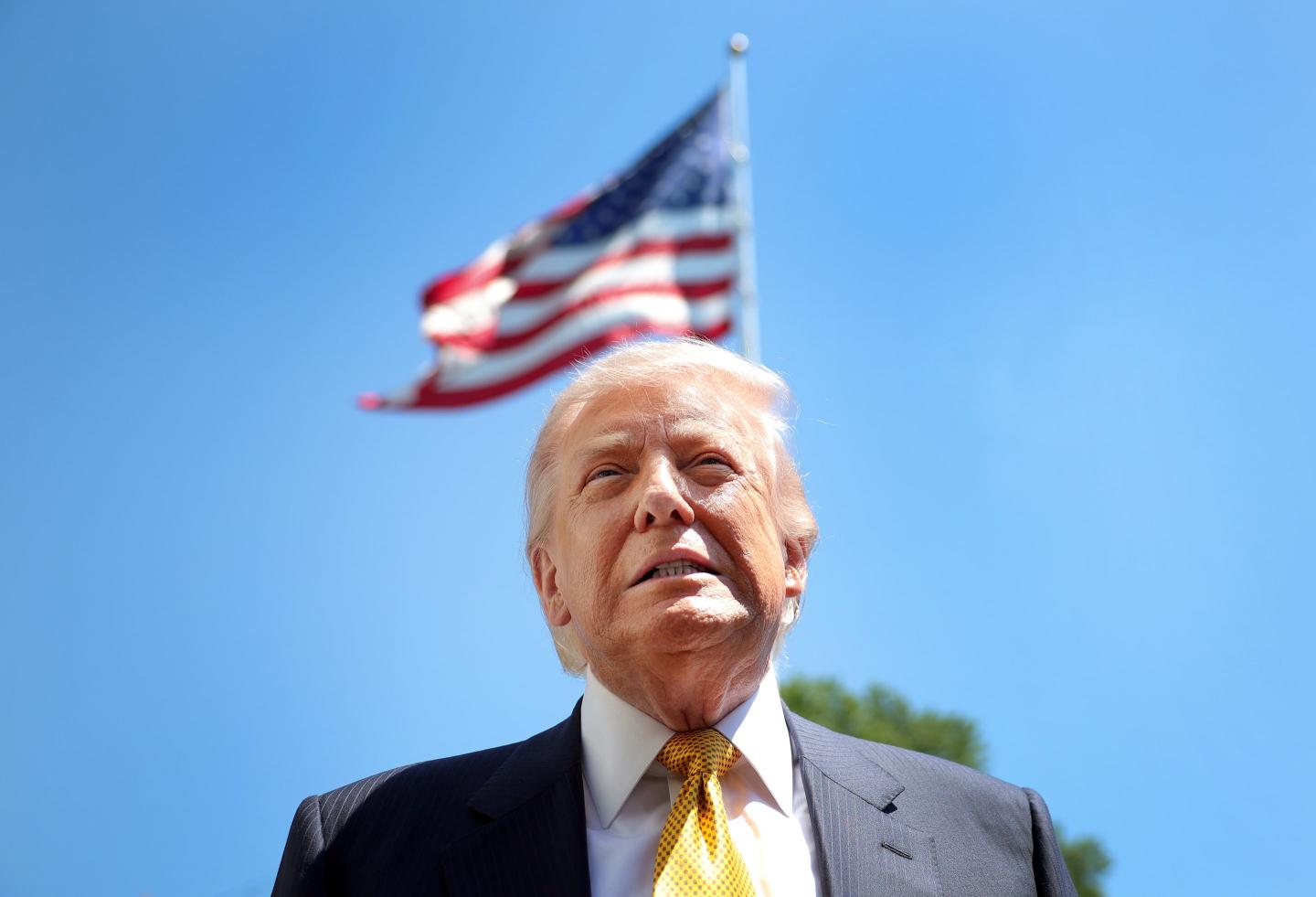 President Donald Trump pictured in front of an American flag.