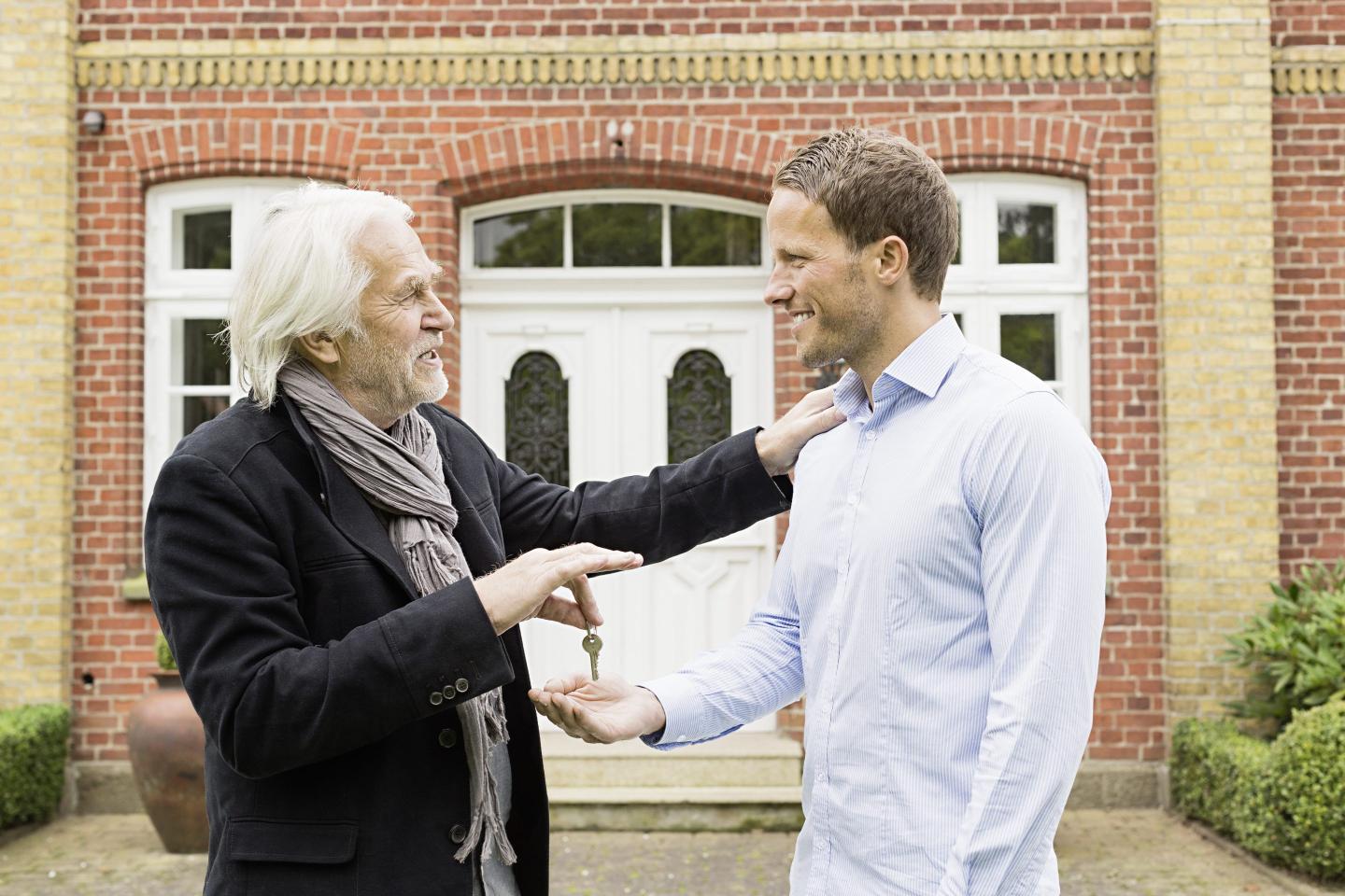 man giving child keys to home