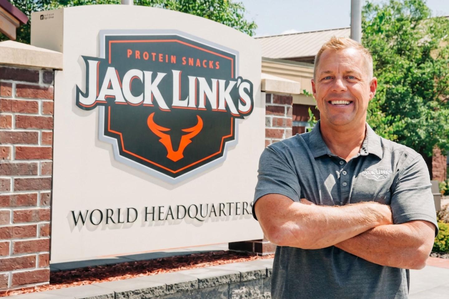 Troy Link outside of a Jack Link's world headquarters sign