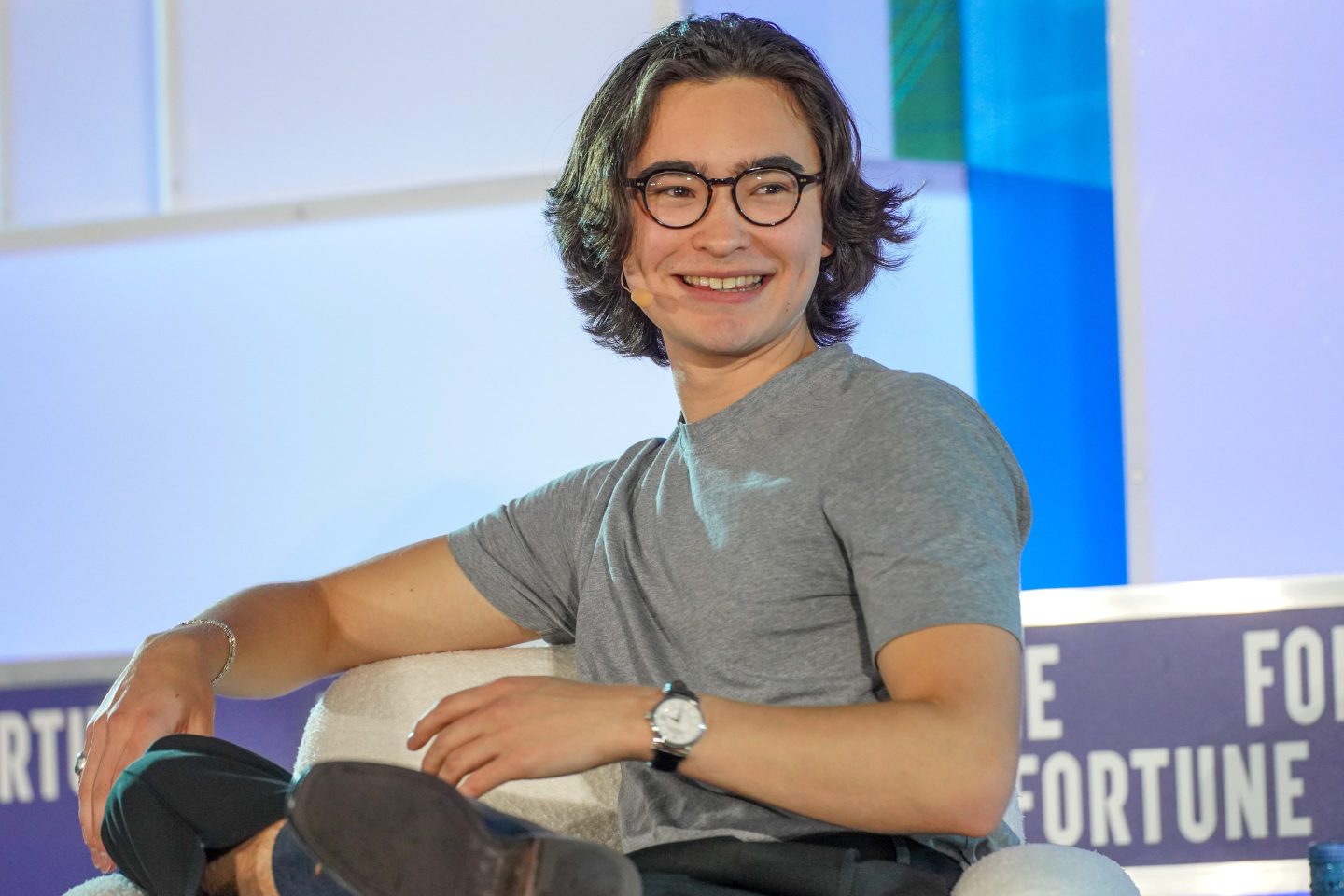 Ned Koh turns in his chair, smiling.