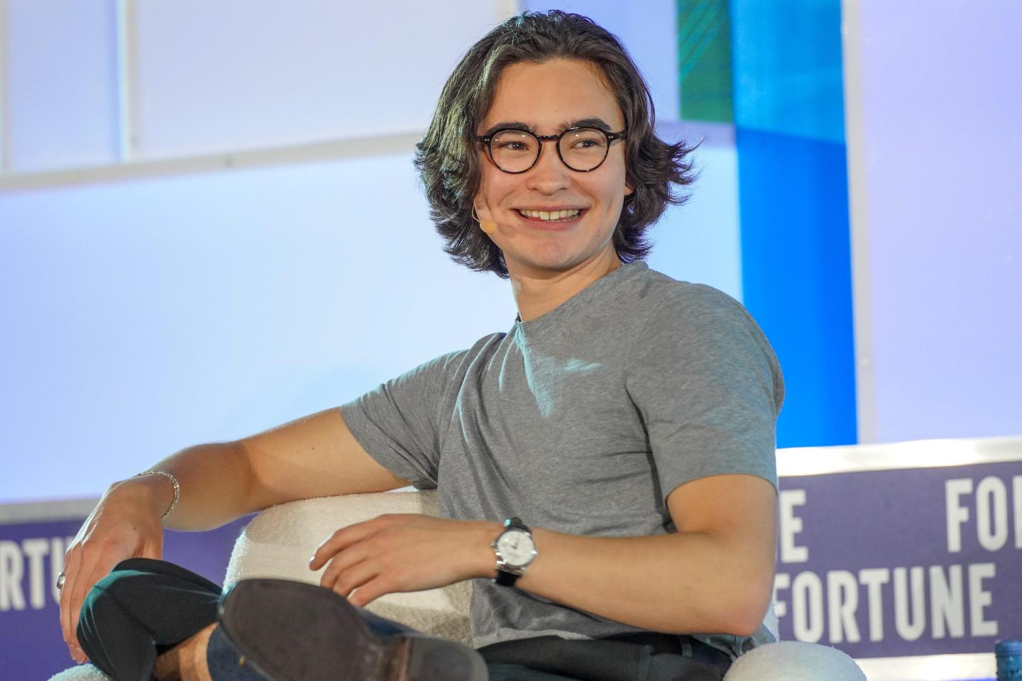 Ned Koh turns in his chair, smiling.