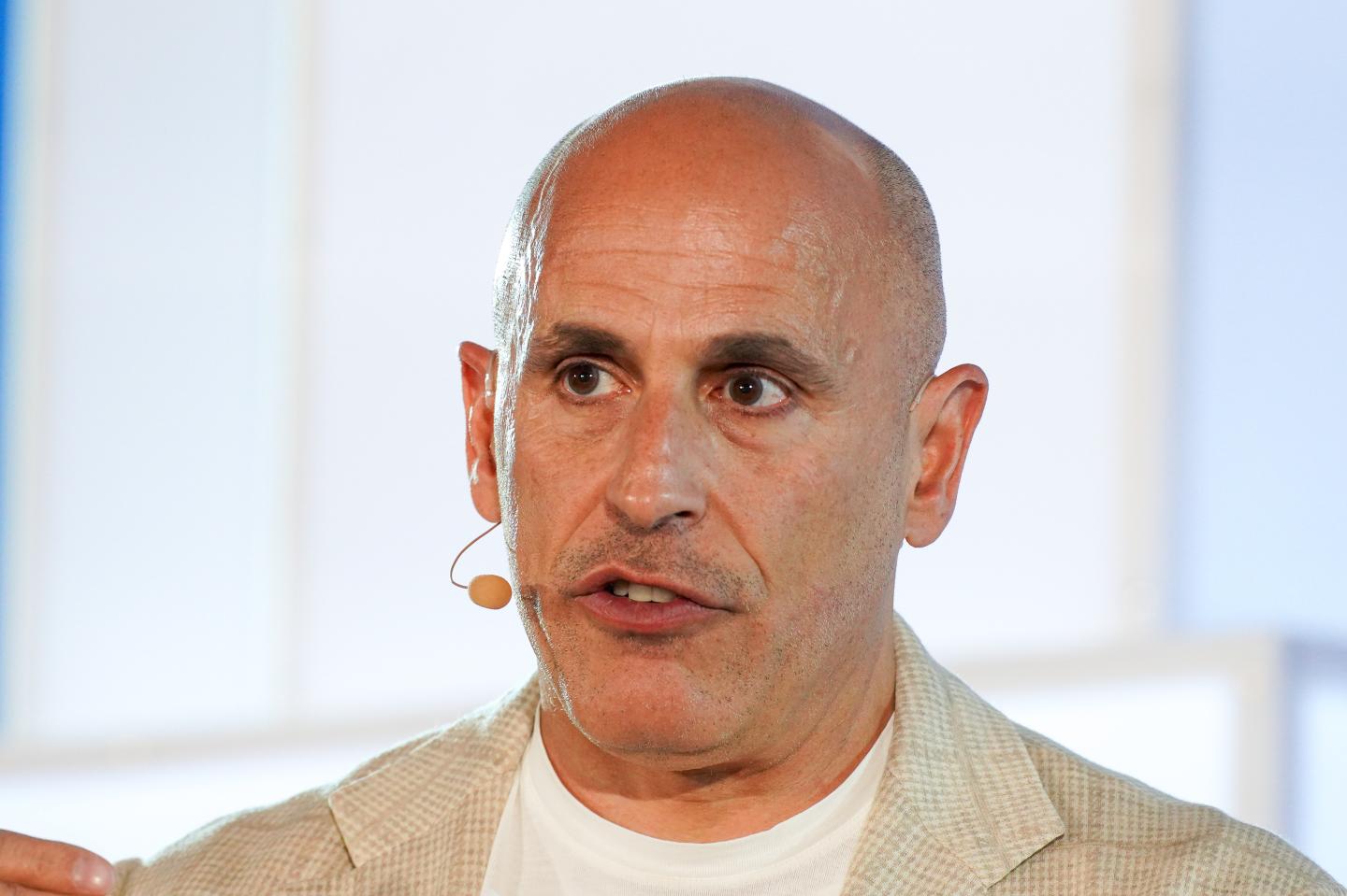 Man in a white shirt and jacket.
